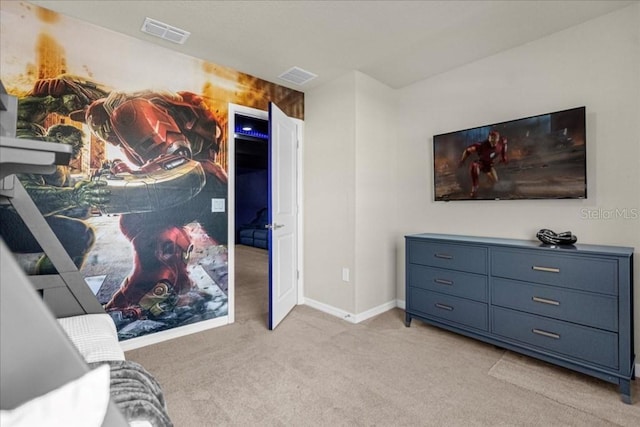 bedroom with visible vents, light carpet, and baseboards