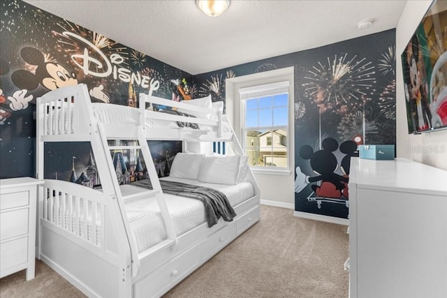 bedroom with carpet flooring, a textured ceiling, baseboards, and wallpapered walls