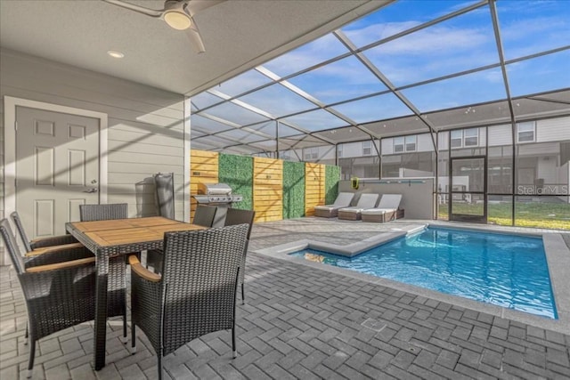 view of swimming pool with ceiling fan, a patio, a lanai, area for grilling, and a hot tub