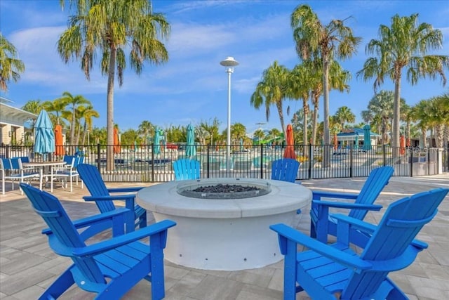 surrounding community featuring an outdoor fire pit, a patio area, and fence