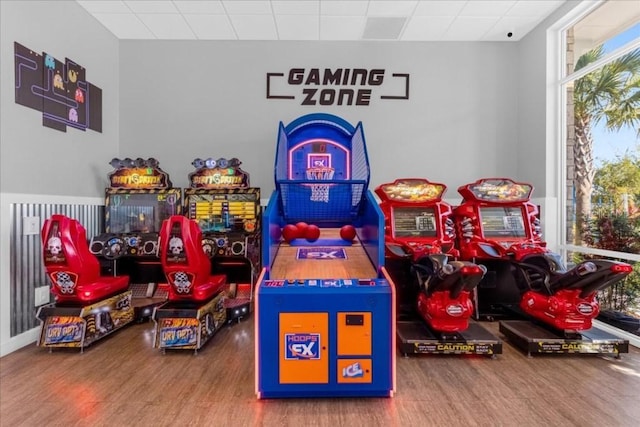 game room with a paneled ceiling and hardwood / wood-style flooring