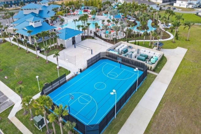 view of basketball court featuring community basketball court, fence, and a lawn