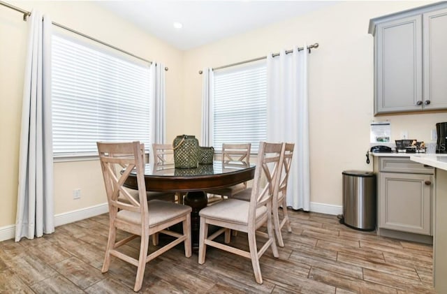 dining room with plenty of natural light and light hardwood / wood-style floors