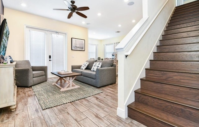 living room with light hardwood / wood-style floors and ceiling fan