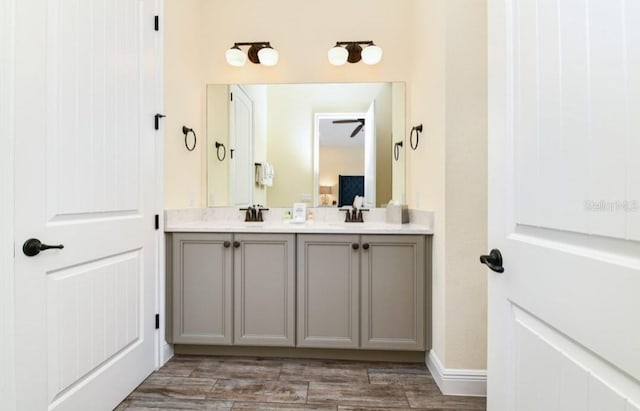 bathroom featuring hardwood / wood-style floors, vanity, and ceiling fan