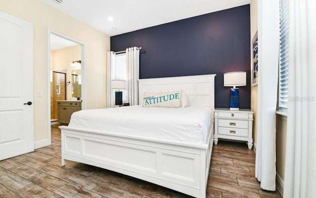 bedroom featuring wood-type flooring and connected bathroom