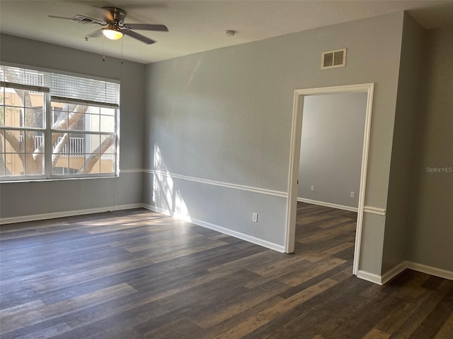 unfurnished room featuring ceiling fan and dark hardwood / wood-style flooring