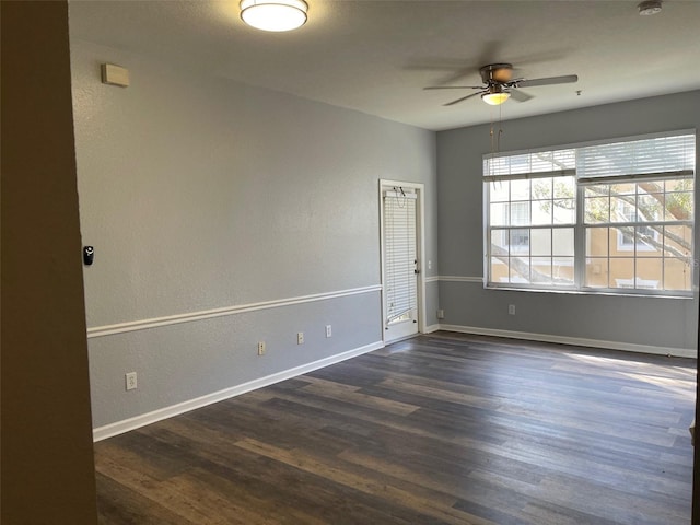 unfurnished room with ceiling fan and dark hardwood / wood-style floors