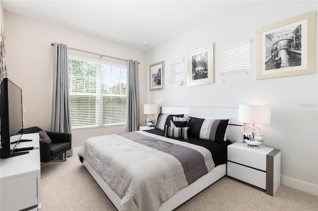 bedroom featuring light carpet