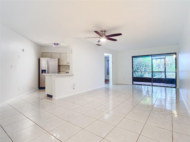 unfurnished living room with ceiling fan and light tile patterned flooring