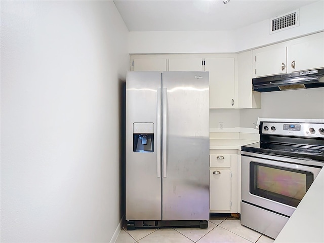 kitchen with light tile patterned floors, white cabinetry, and appliances with stainless steel finishes