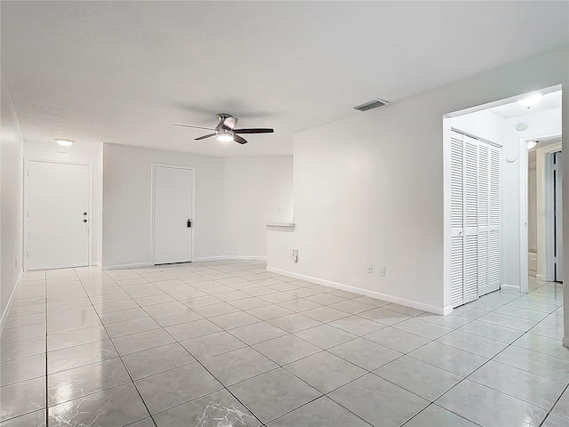 tiled empty room with ceiling fan