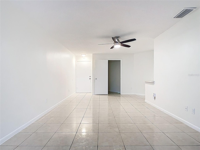 tiled empty room with ceiling fan