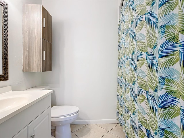 bathroom featuring toilet, tile patterned floors, and vanity