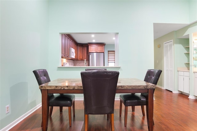 dining space featuring dark wood-type flooring