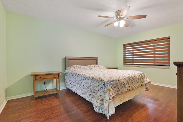 bedroom with ceiling fan, dark hardwood / wood-style flooring, and a textured ceiling