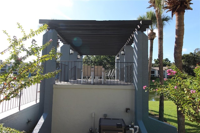 view of property exterior with a balcony and a pergola