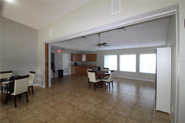 tiled dining space featuring ceiling fan