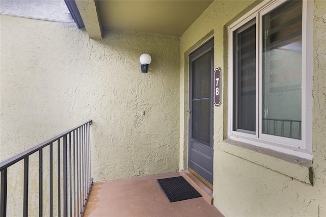 8 Escondido Cir Unit 78, Altamonte Springs, FL 32701 - view of exterior entry featuring stucco siding and a balcony
