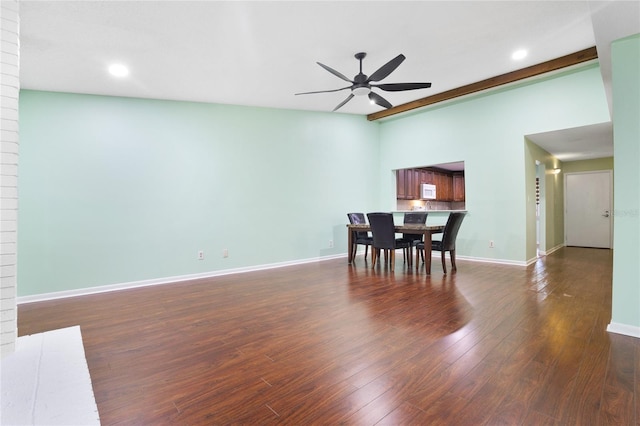 dining room with brick wall, ceiling fan, and dark hardwood / wood-style floors