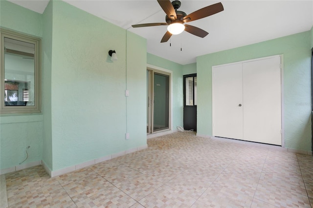 unfurnished bedroom with ceiling fan and light tile patterned floors