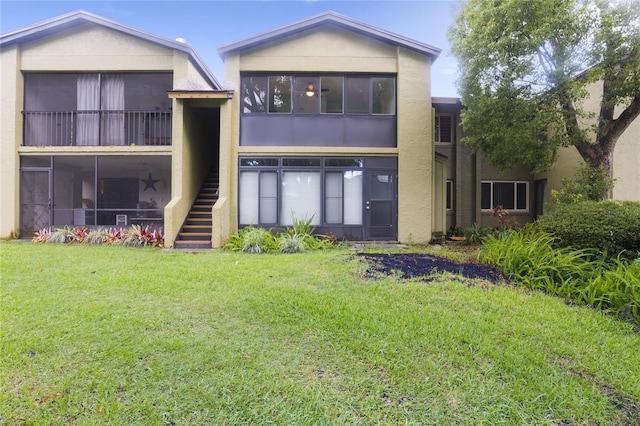 8 Escondido Cir Unit 78, Altamonte Springs, FL 32701 - back of house featuring stucco siding, stairs, and a lawn