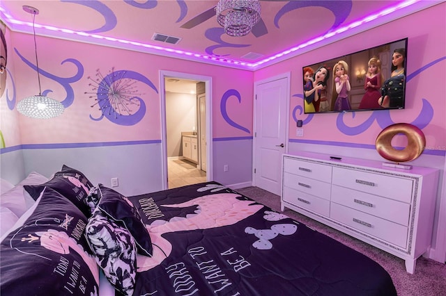 carpeted bedroom featuring ceiling fan and ensuite bath