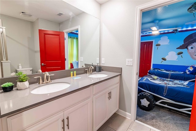 bathroom with tile patterned floors, vanity, and toilet