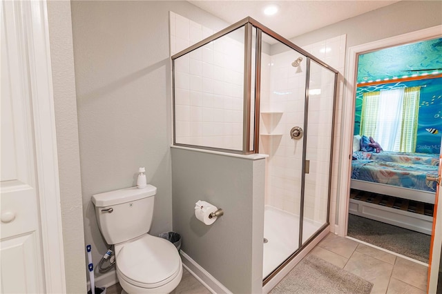 bathroom featuring toilet, tile patterned flooring, and walk in shower