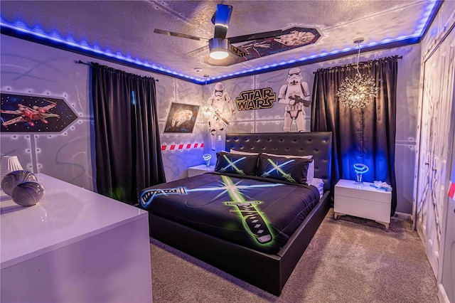 carpeted bedroom with a textured ceiling and ceiling fan