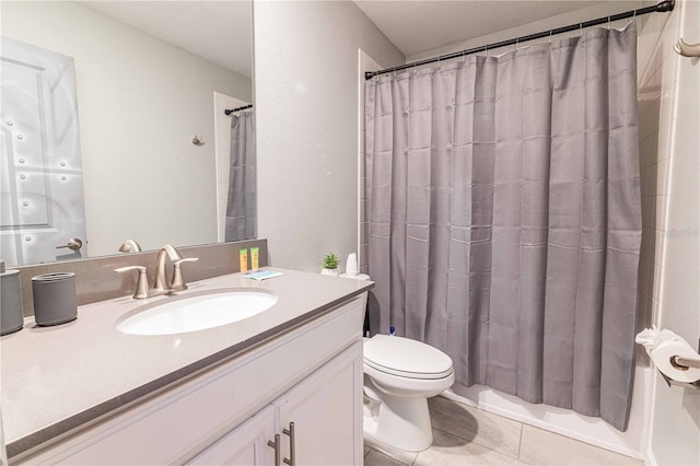 bathroom with toilet, vanity, tile patterned floors, and curtained shower