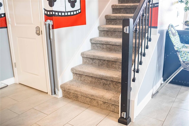 staircase featuring tile patterned flooring