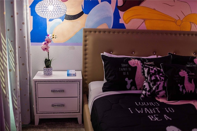 carpeted bedroom with a notable chandelier