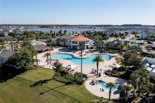 view of pool featuring a yard, a patio, and a water view