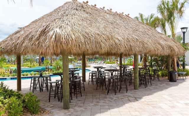 view of property's community featuring a gazebo, a pool, and a patio