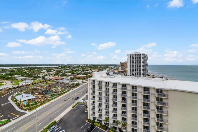 drone / aerial view with a water view and a beach view