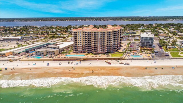 bird's eye view with a water view and a beach view