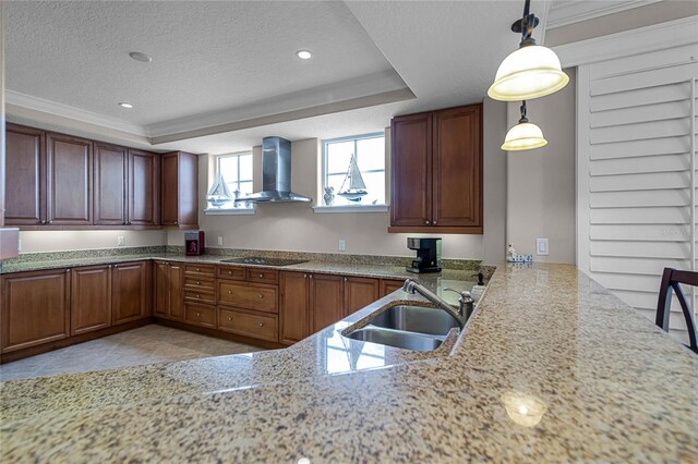 kitchen featuring pendant lighting, sink, crown molding, wall chimney range hood, and black electric cooktop