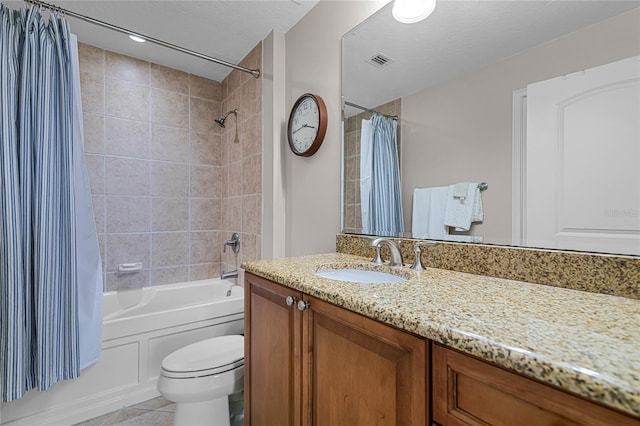 full bathroom featuring tile patterned floors, toilet, shower / tub combo, a textured ceiling, and vanity