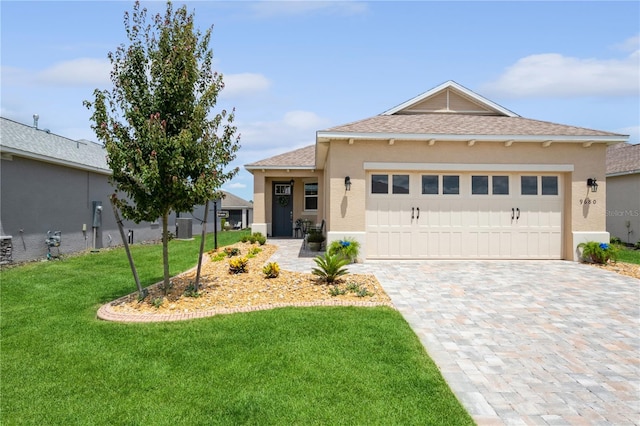 view of front of property featuring a garage and a front yard