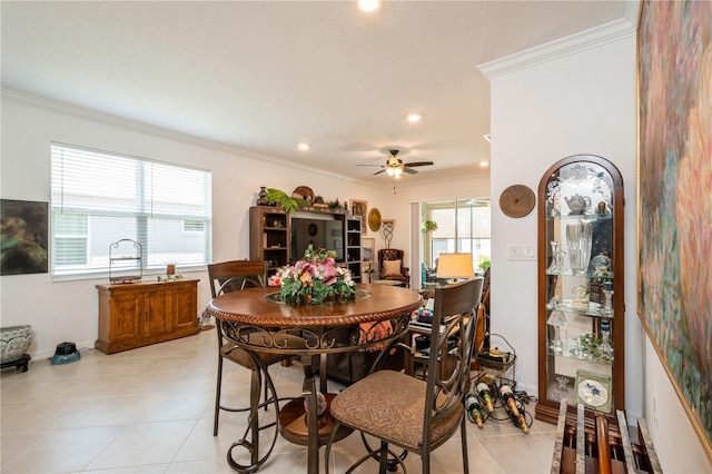 dining area with light tile patterned floors, ceiling fan, and ornamental molding