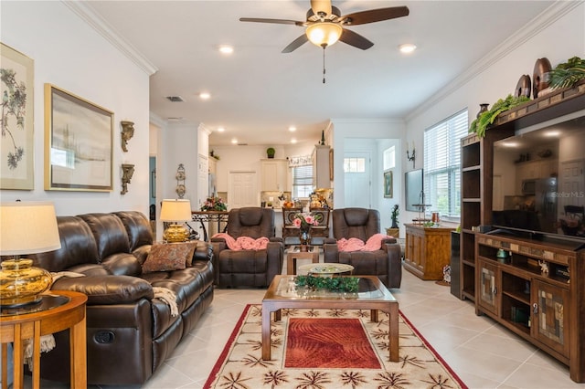 tiled living room with ceiling fan and crown molding