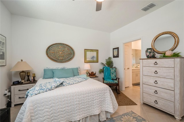 tiled bedroom featuring ensuite bath and ceiling fan