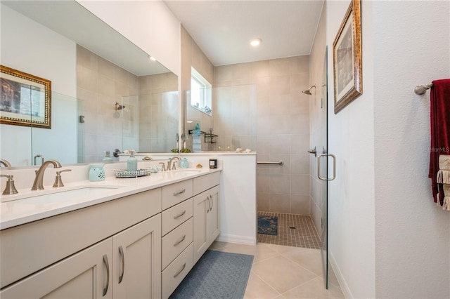 bathroom with tile patterned flooring, vanity, and a shower with shower door