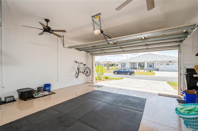 garage featuring ceiling fan and a garage door opener