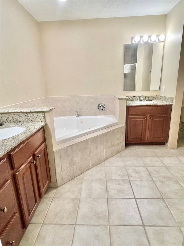 bathroom featuring tiled bath, dual vanity, and tile floors