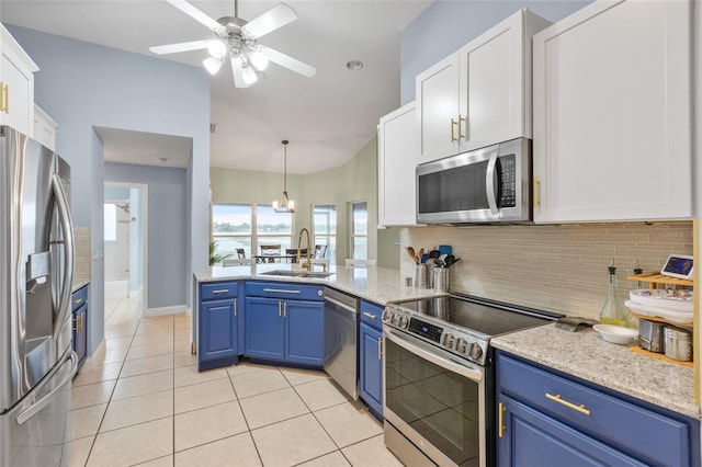 kitchen with pendant lighting, white cabinets, blue cabinets, sink, and stainless steel appliances