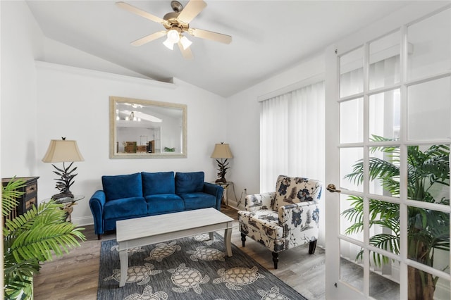 living room with ceiling fan, plenty of natural light, wood-type flooring, and lofted ceiling