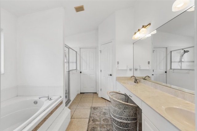 bathroom featuring tile patterned floors, vanity, separate shower and tub, and vaulted ceiling