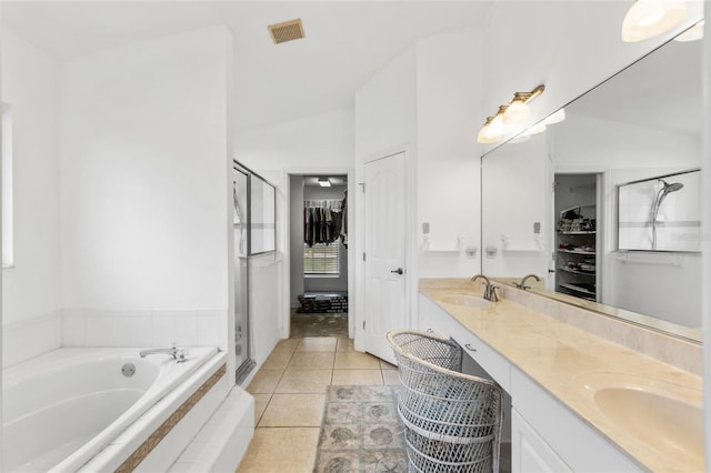 bathroom with plus walk in shower, vanity, tile patterned floors, and vaulted ceiling